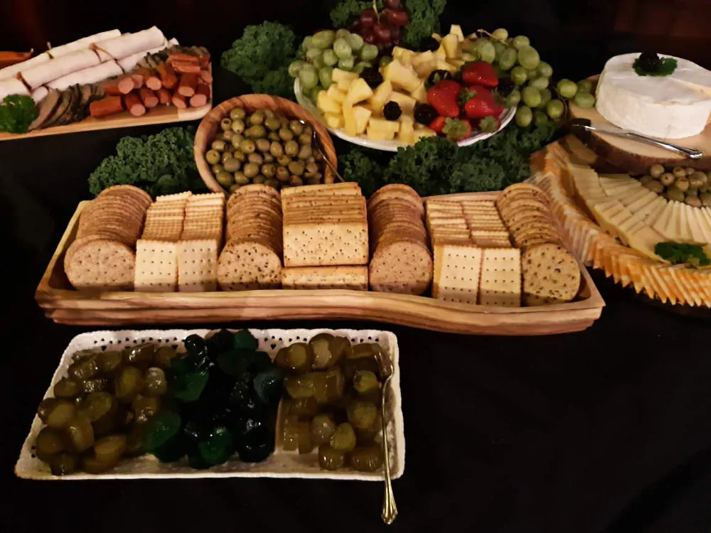 An assortment of crackers arranged neatly on a wooden tray.